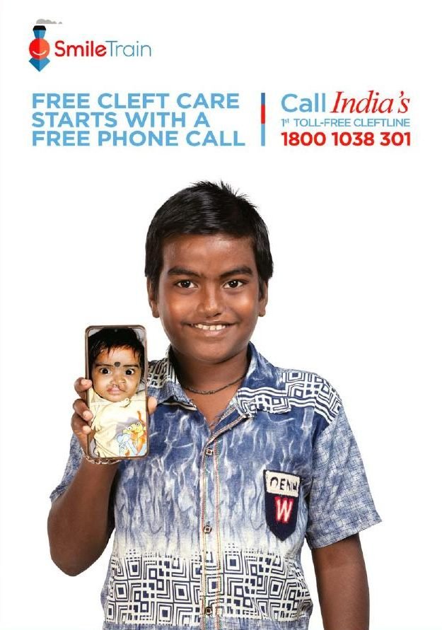 Smile Train poster: a boy holds a phone showing his younger self before cleft surgery